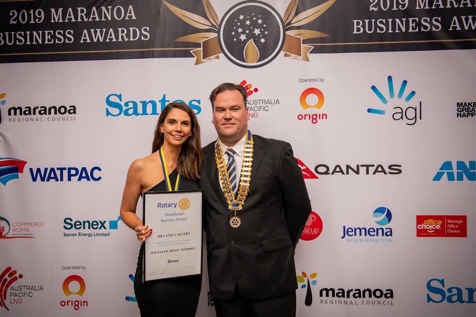 Melanie Calvert receiving the 2019 Jim Baker Medal from President Scott McDonell